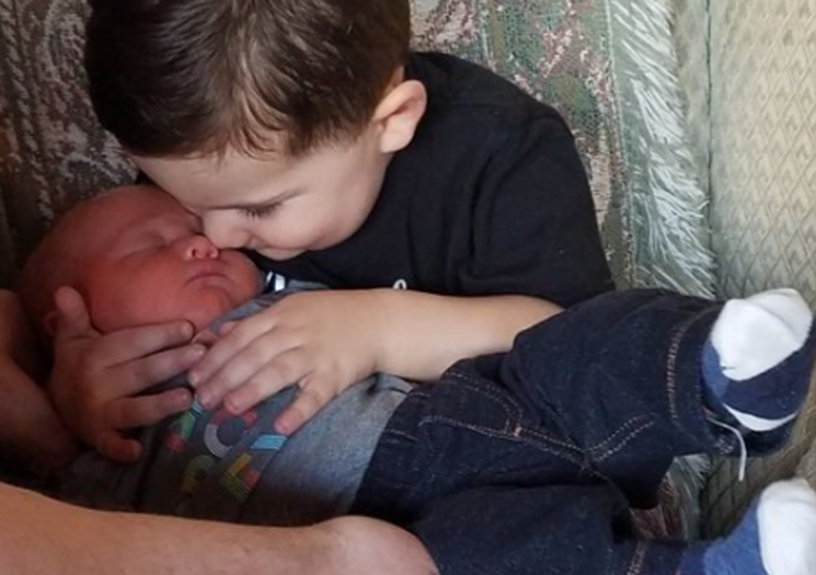 Joey holding his new little brother, Aidan