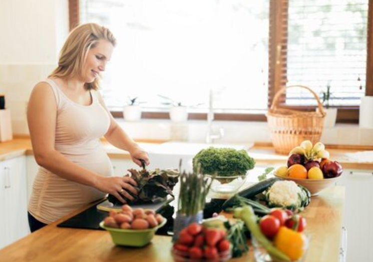 Pregnant woman preparing meal